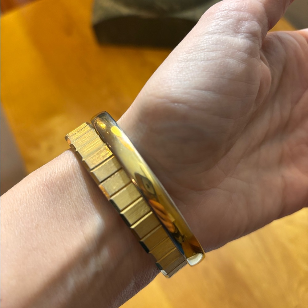 Two vintage Monet gold tone bangle bracelets. Both are 2.5” in diameter.